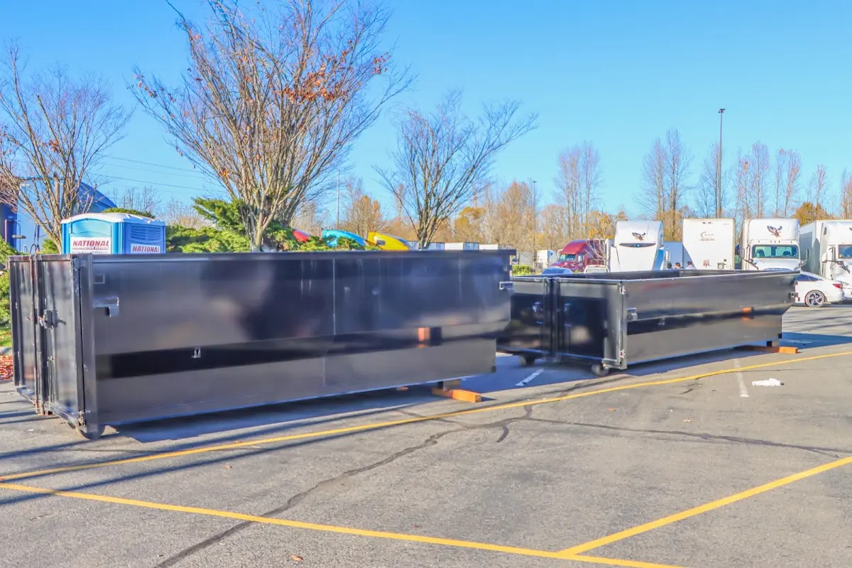 Professional dumpster rental service with roll-off container on residential driveway in Montville